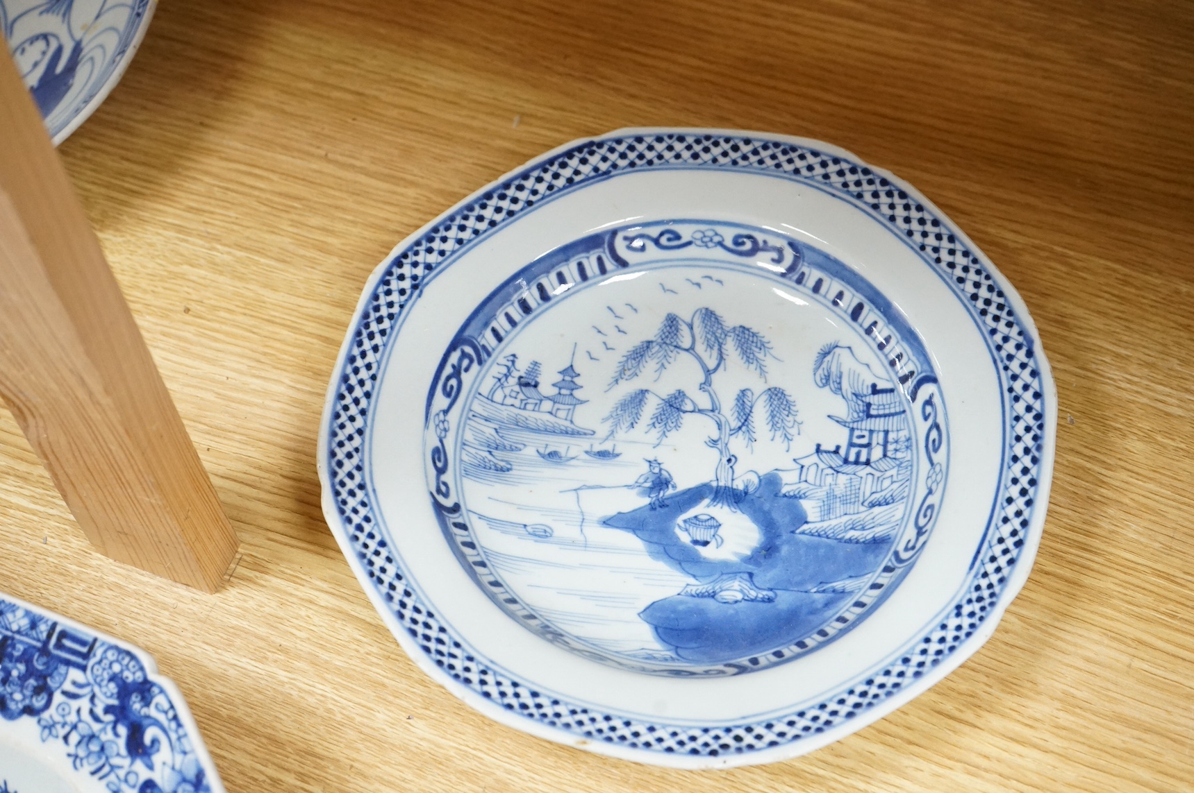 A 18th century Chinese export blue and white octagonal serving dish and two blue and white dishes, largest 38cm wide. Condition - one plate cracked
